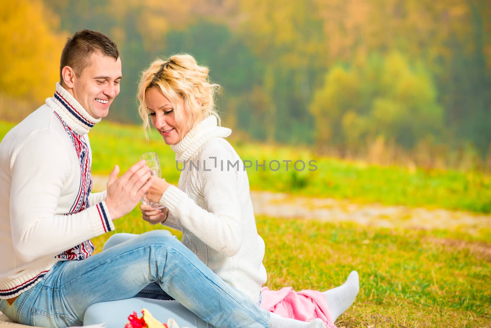 heterosexual couple relaxing cheerfully in the park by kosmsos111