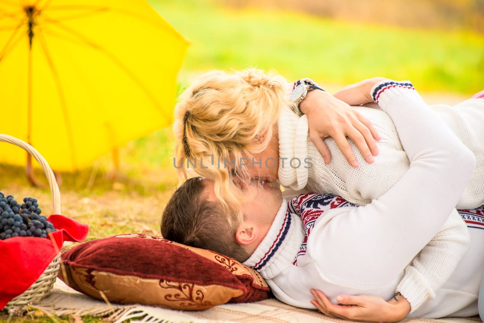 kissing couple on the plaid in autumn park