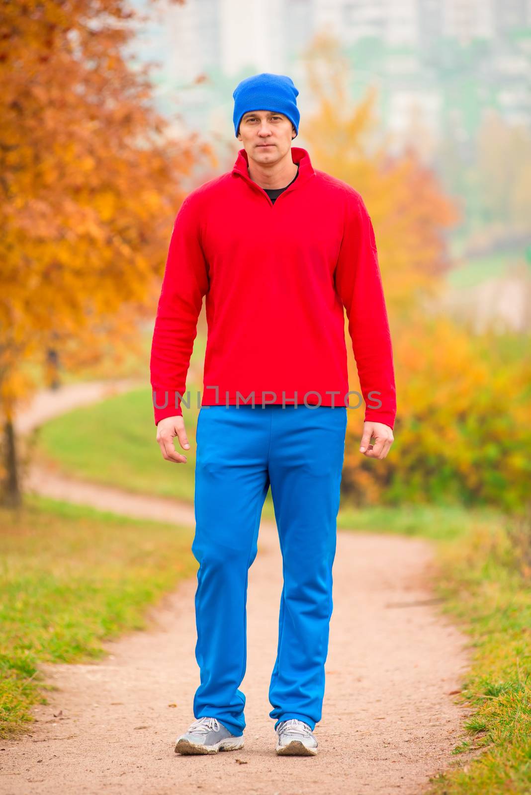 male athlete on training in autumn park by kosmsos111