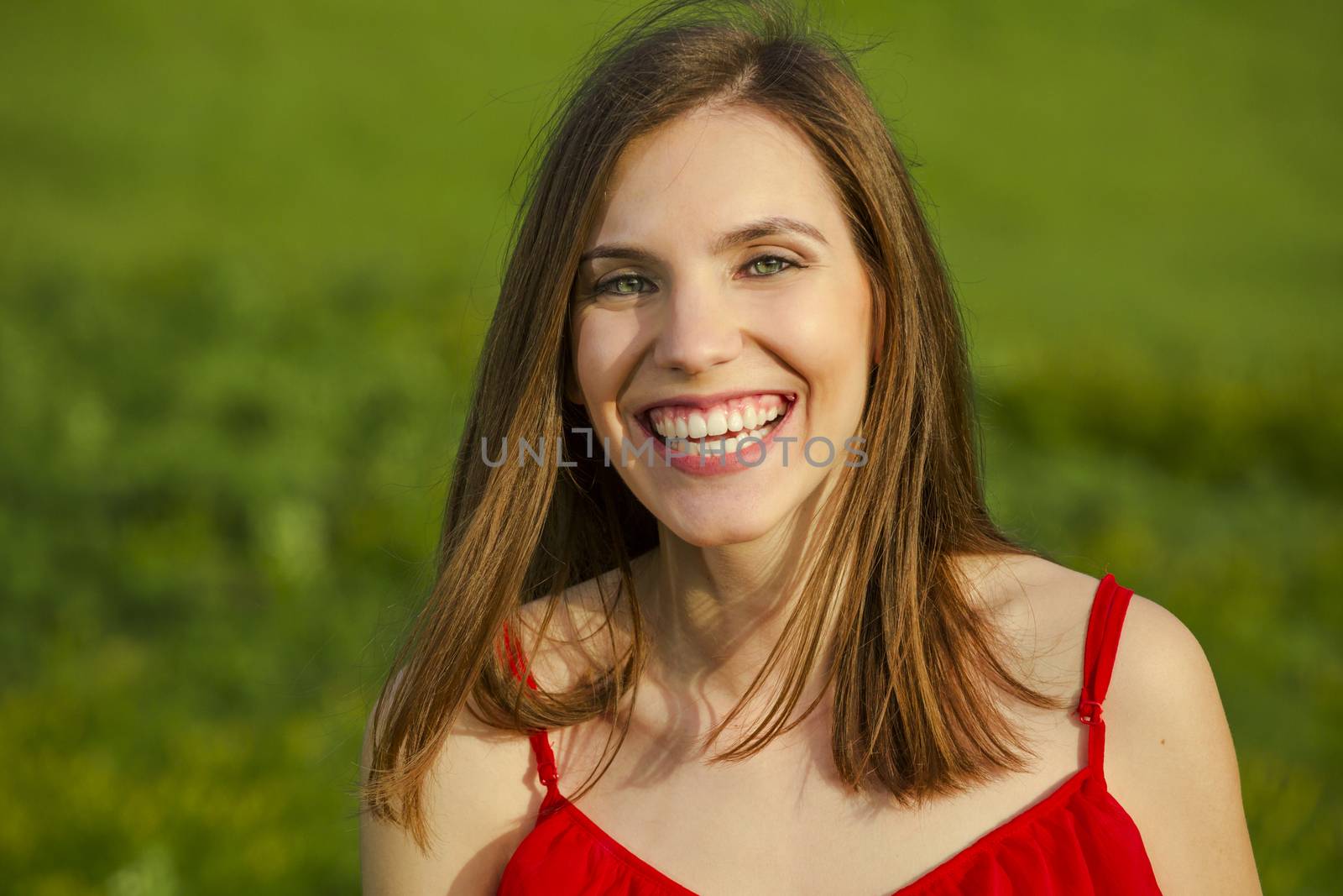Young beautiful woman in a red dress smiling
