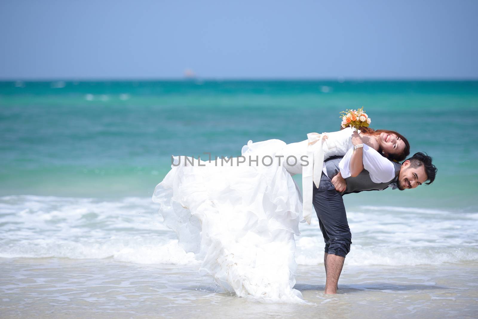 just married young couple celebrating and have fun at beautiful  by numskyman