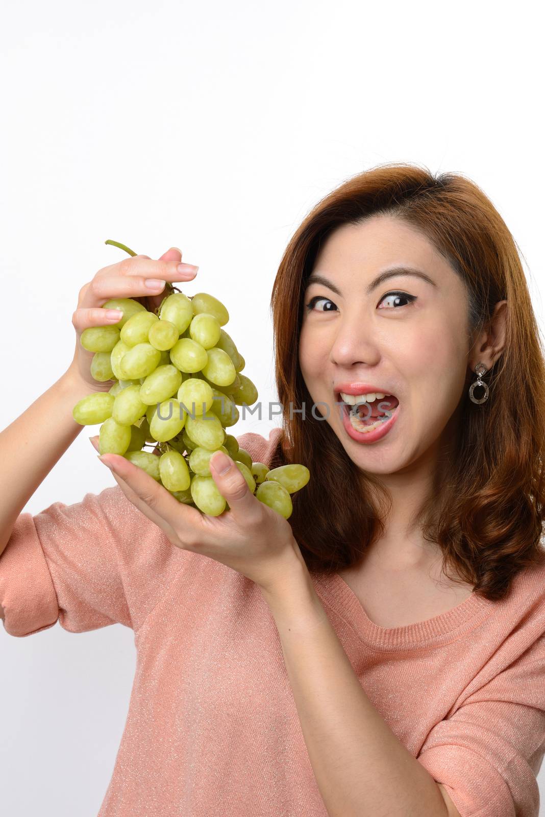 Beautiful asian woman shocked expression while holding grape by numskyman