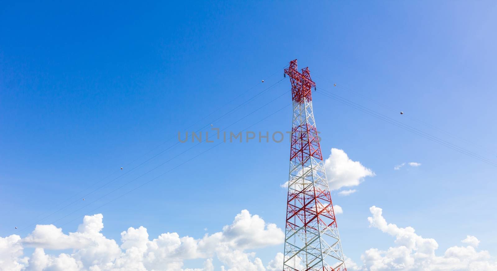 Telecommunication mast with microwave link and TV transmitter antennas on blue sky