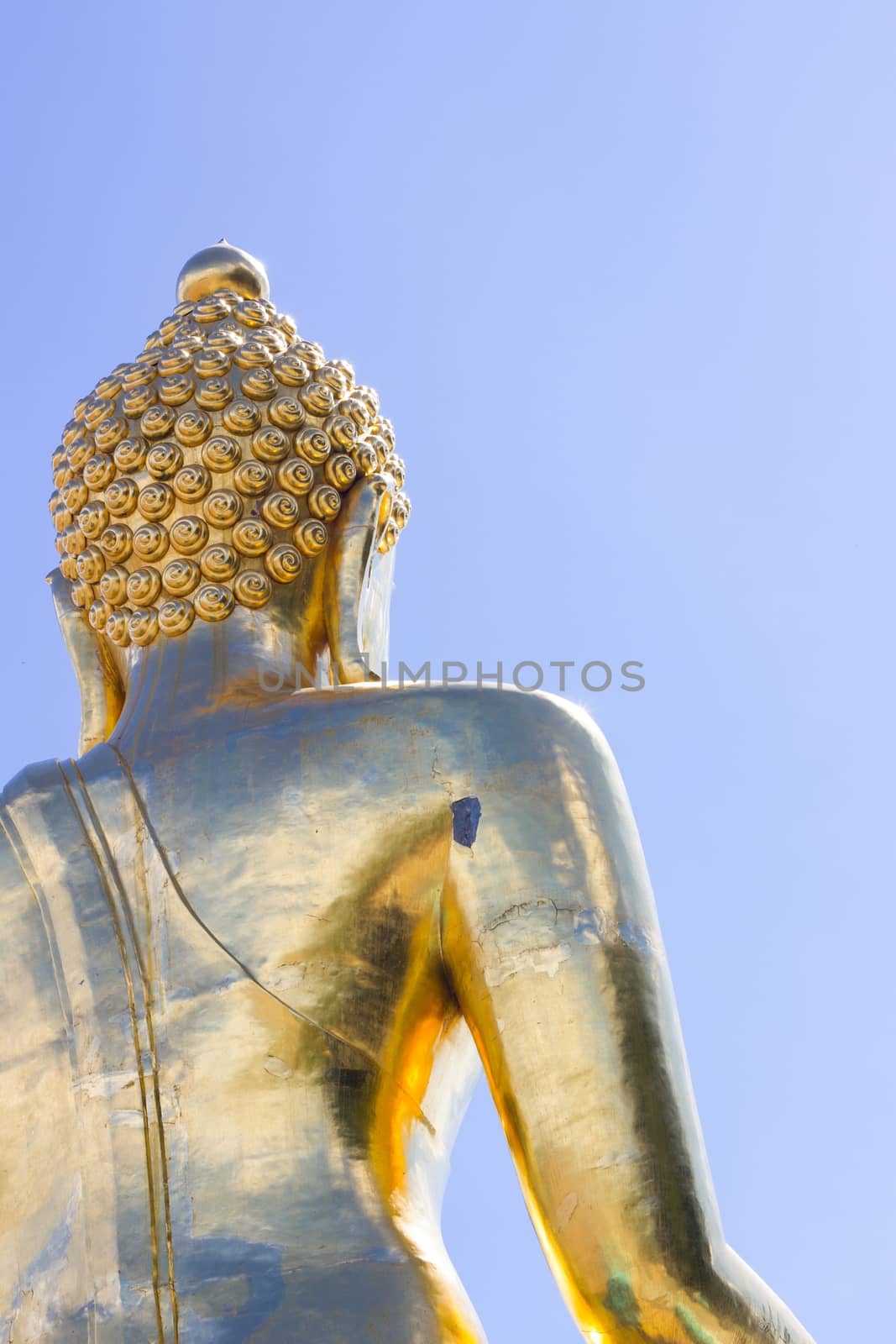 close-up back view big Buddha statue in thailand on blue sky bac by a3701027