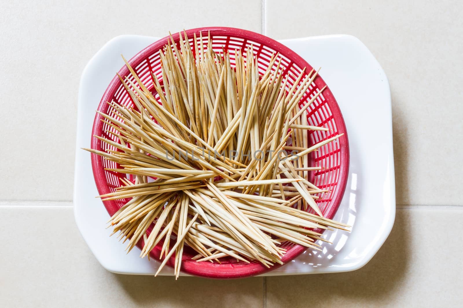 wooden tooth picks in red plastic basket