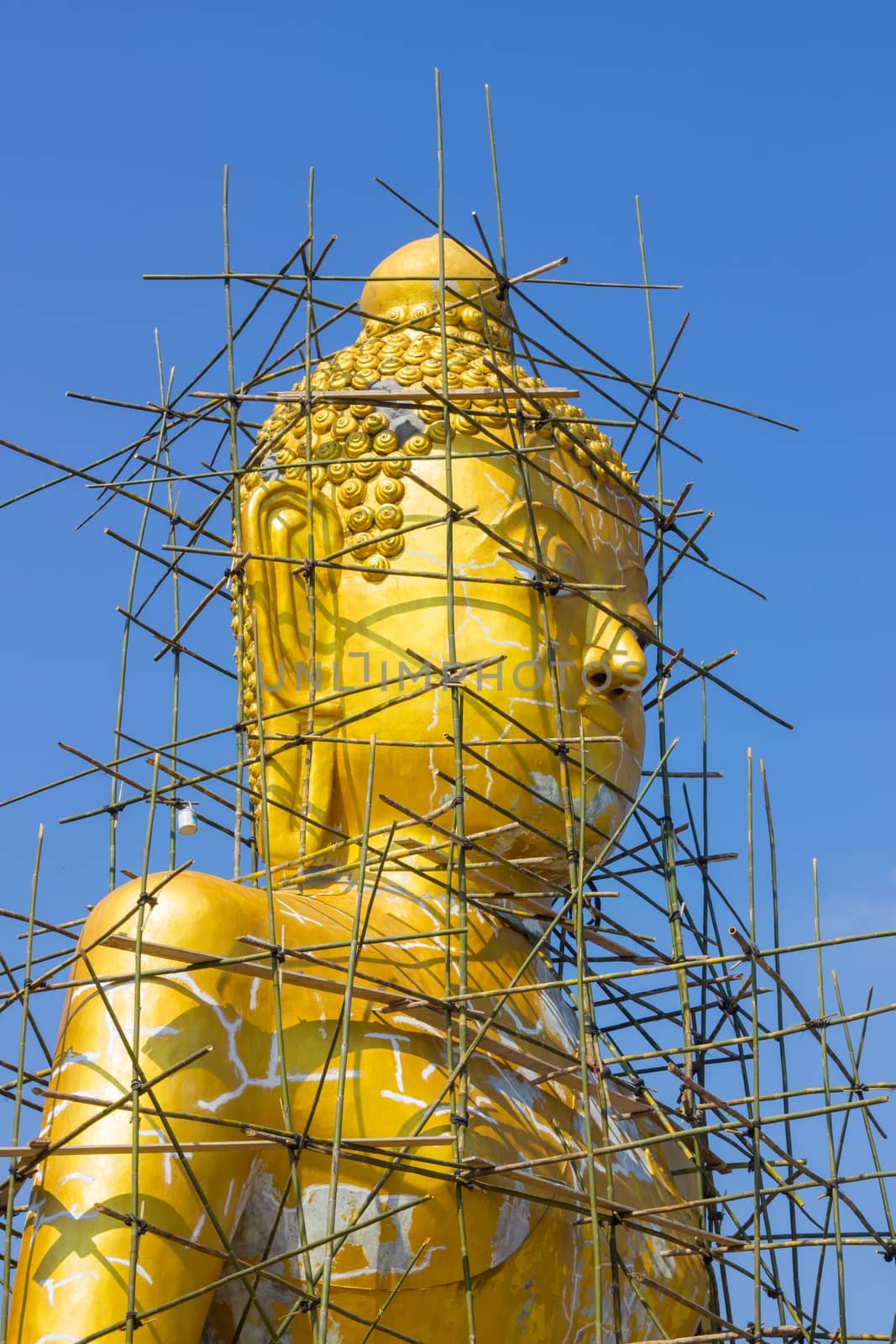 Buddha image reparation on the blue sky.