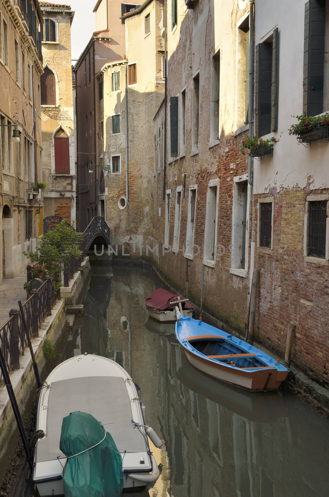 Boats parked at a narrow canal in Venice, Italy