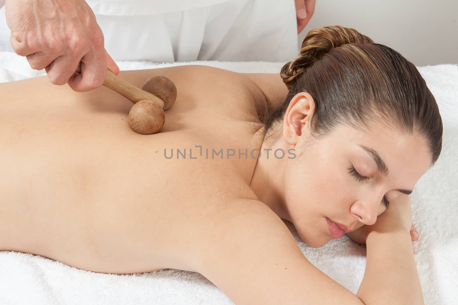 Man massaging a woman with a special tool