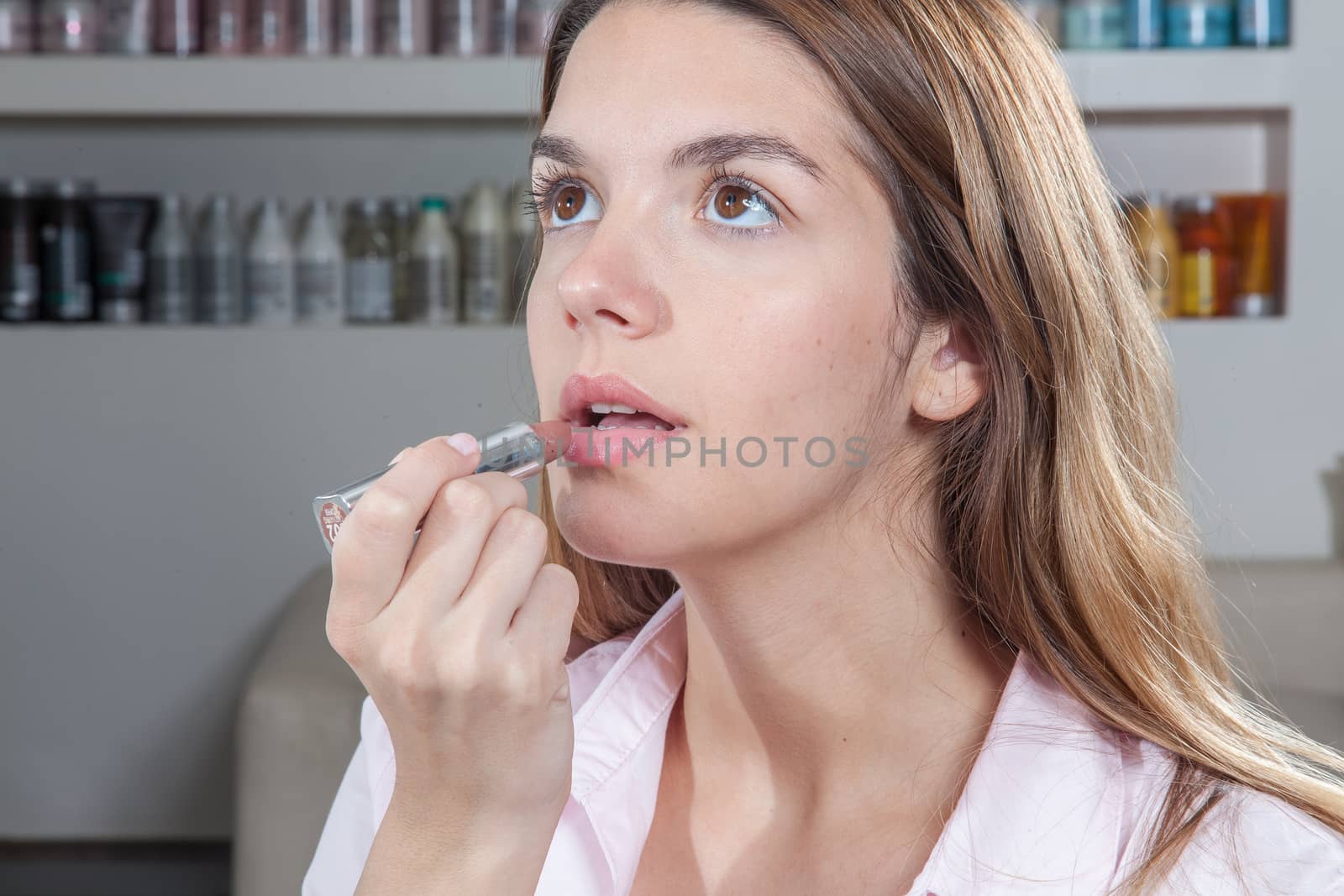 Woman applying her lipstick