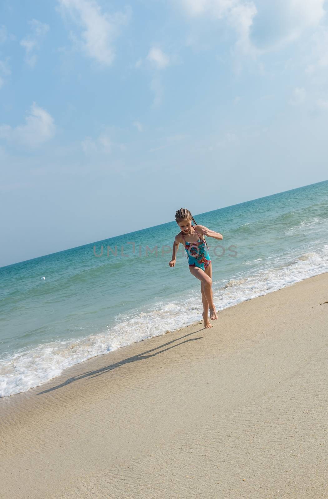 little girl on the sunny sea beach