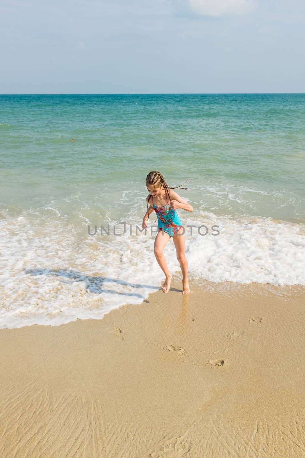 little girl on the sunny sea beach