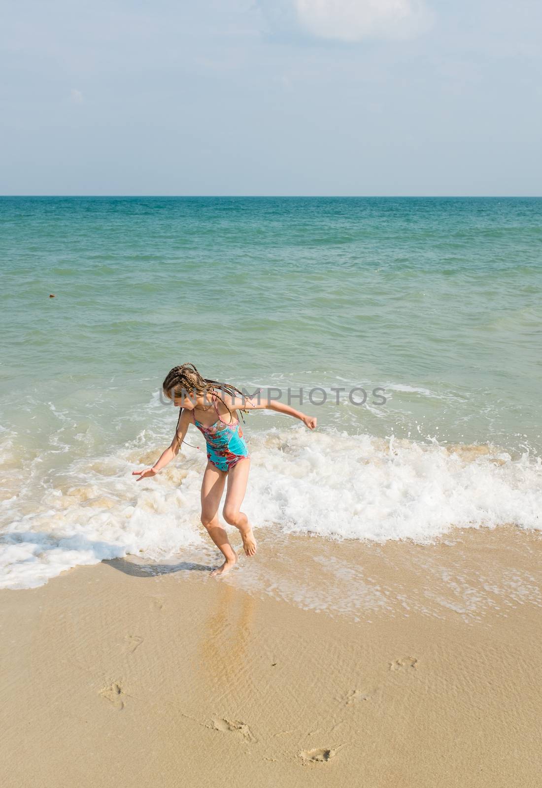 little girl on the sunny sea beach