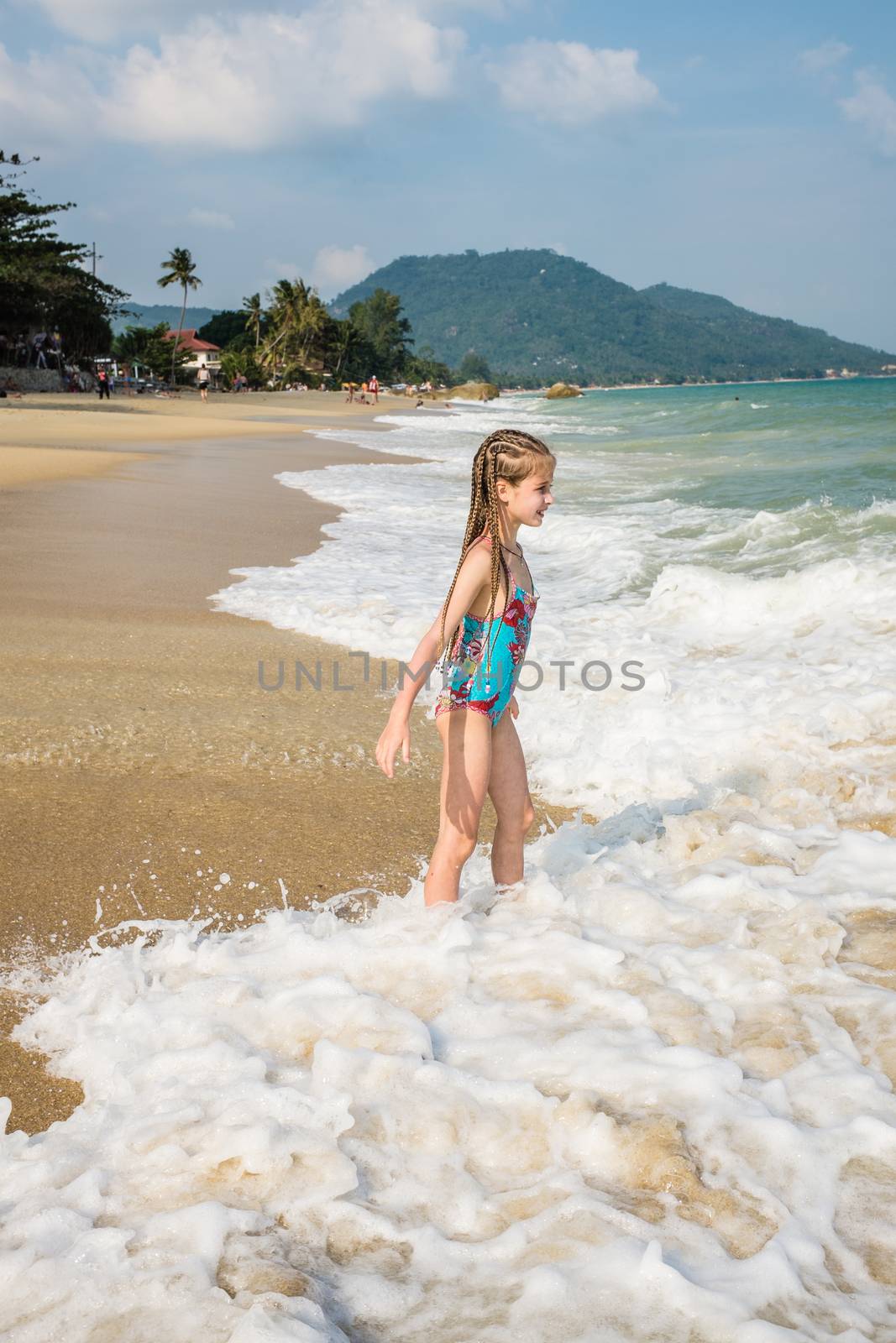 little girl on the sunny sea beach