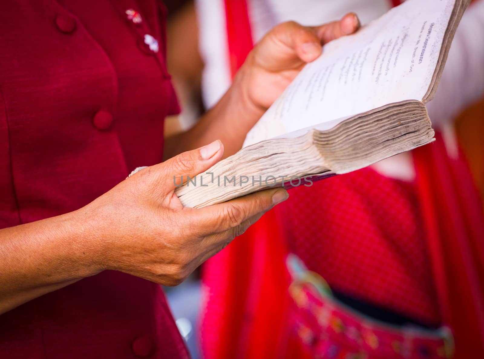 Hand holding book to read while sitting in a car, concept of eye health problem, Very short depth-of-field