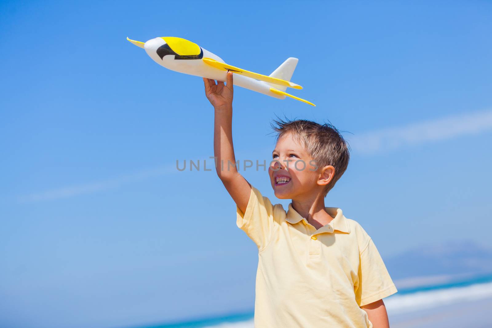 Beach kid boy kite flying outdoor coast ocean