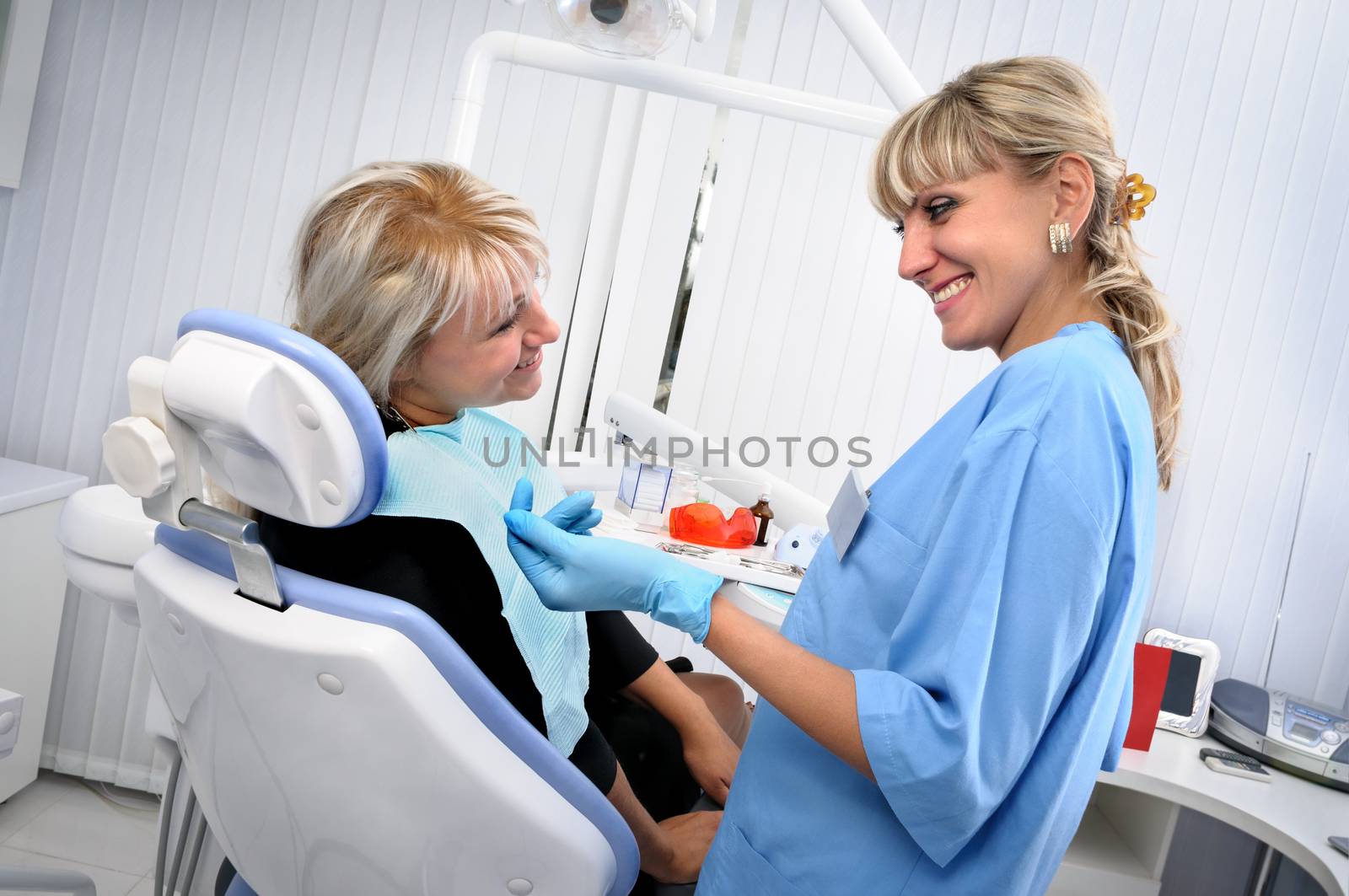 dentist at work with patient, exam, cleaning, curing, using dental water jet