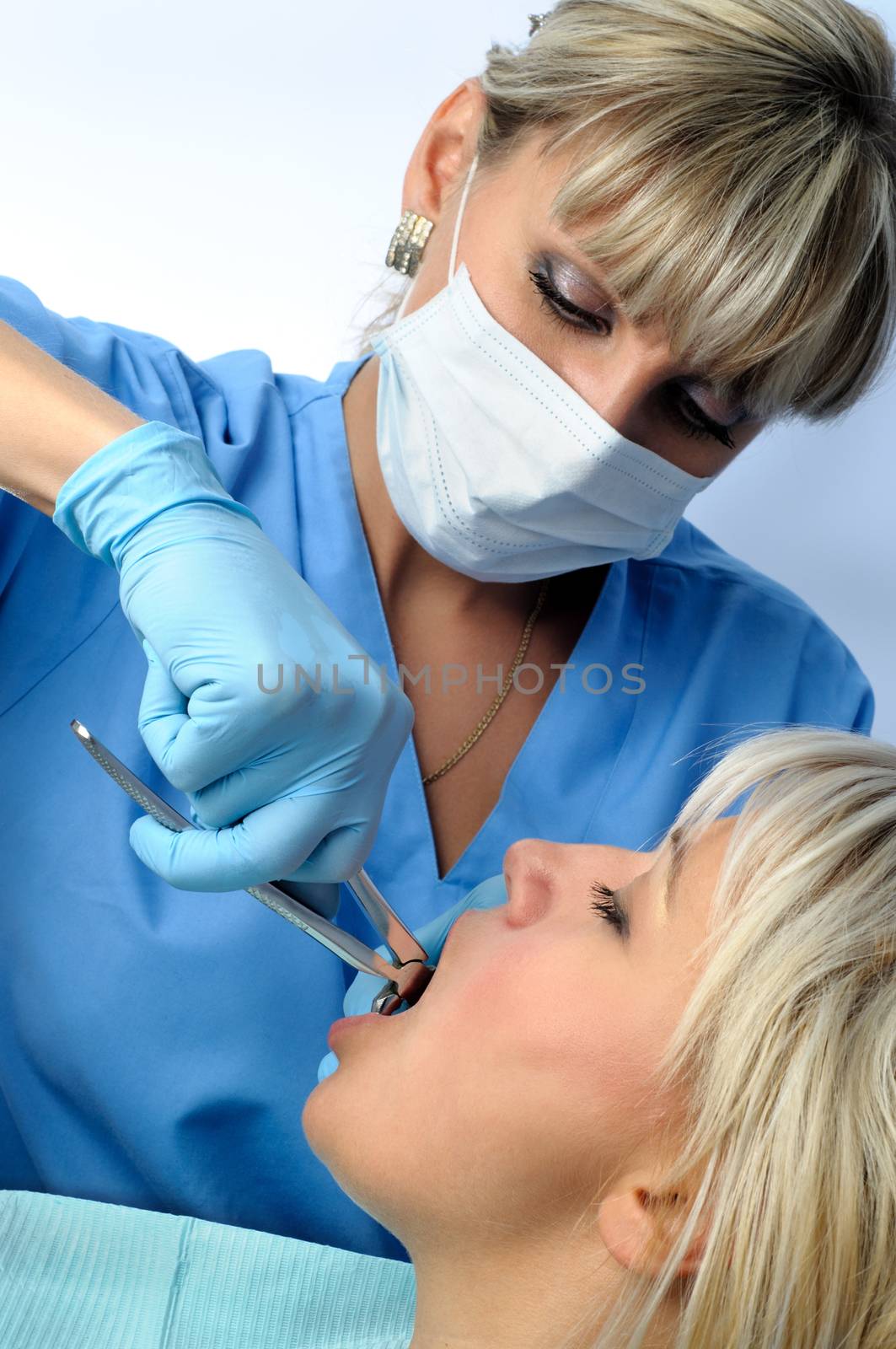 Dentist at work, tooth extraction using forceps