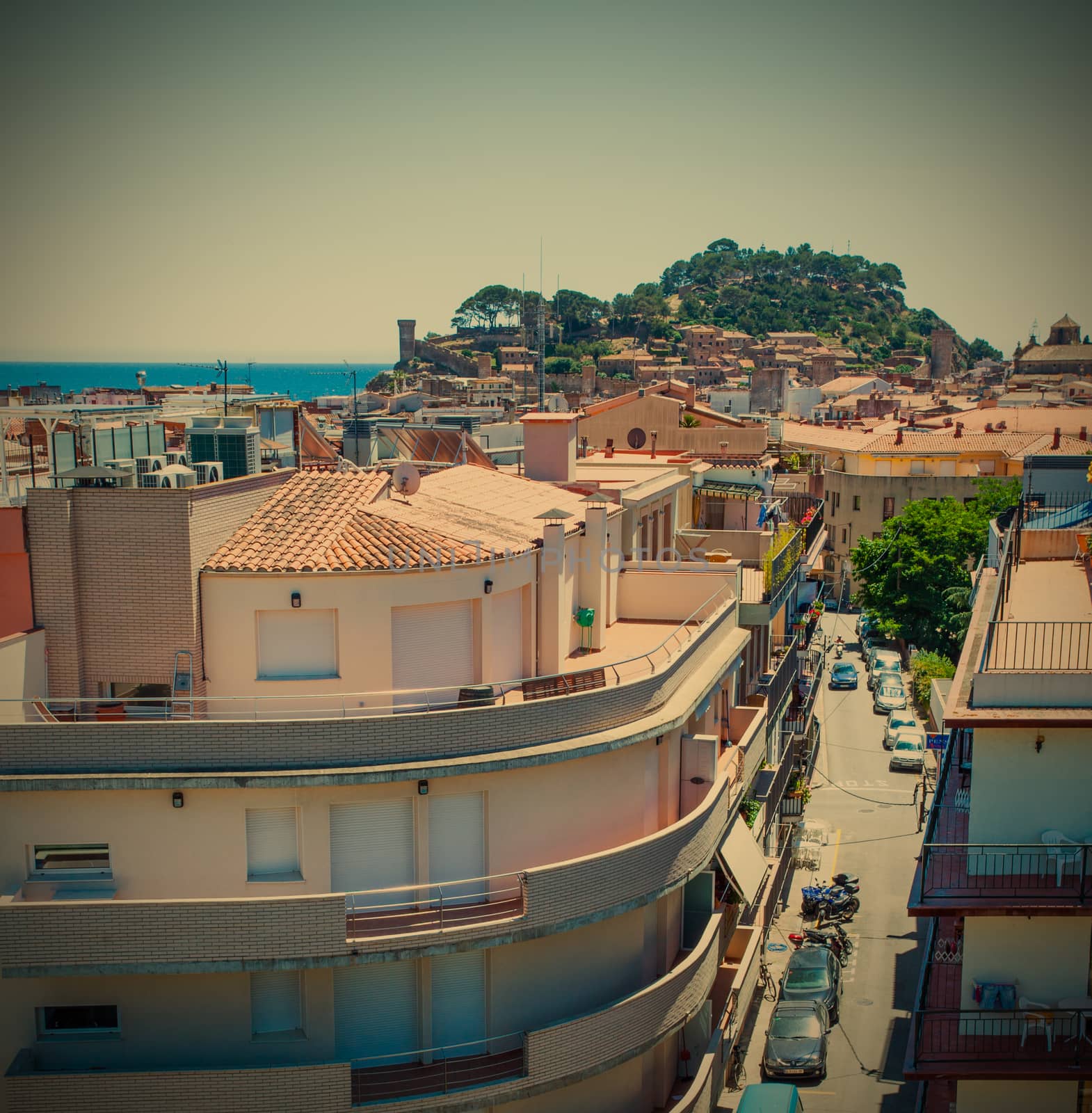Spain, Catalunya, Tossa de Mar, 06.20.2013, the panorama of the town with the Carrer Tomas Barber street and the Mediterranean Sea with the old medieval fortress Villa Vella, instagram style filter, editorial use only
