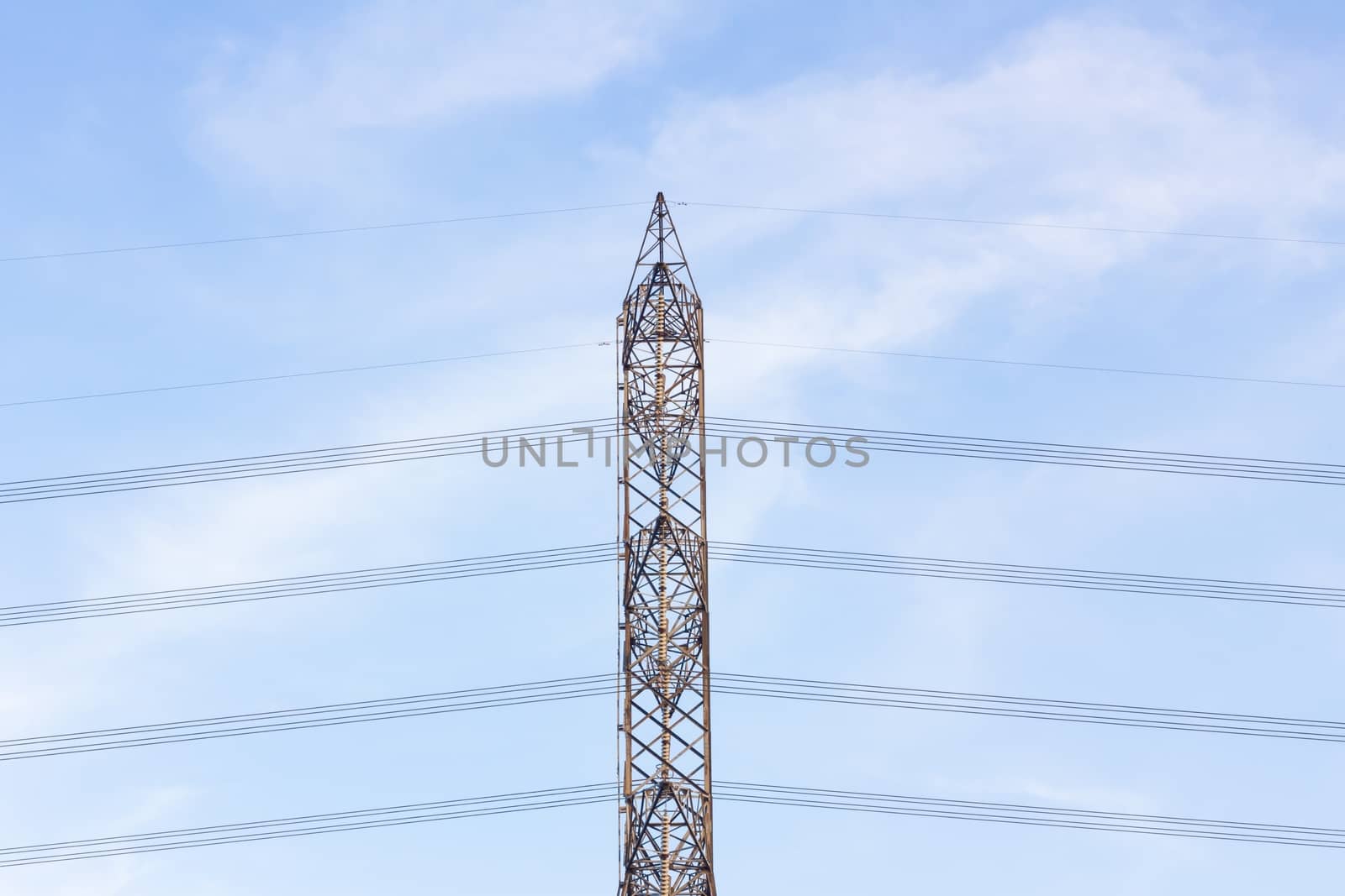 View side of high voltage poles in blue sky with cloud