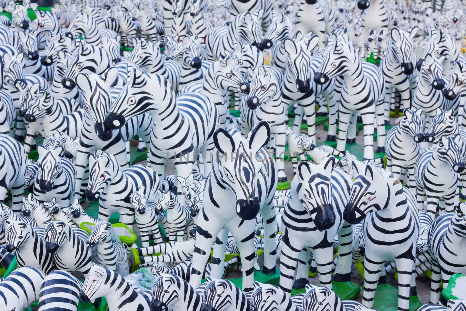 Zebra statues with black and white lines as background