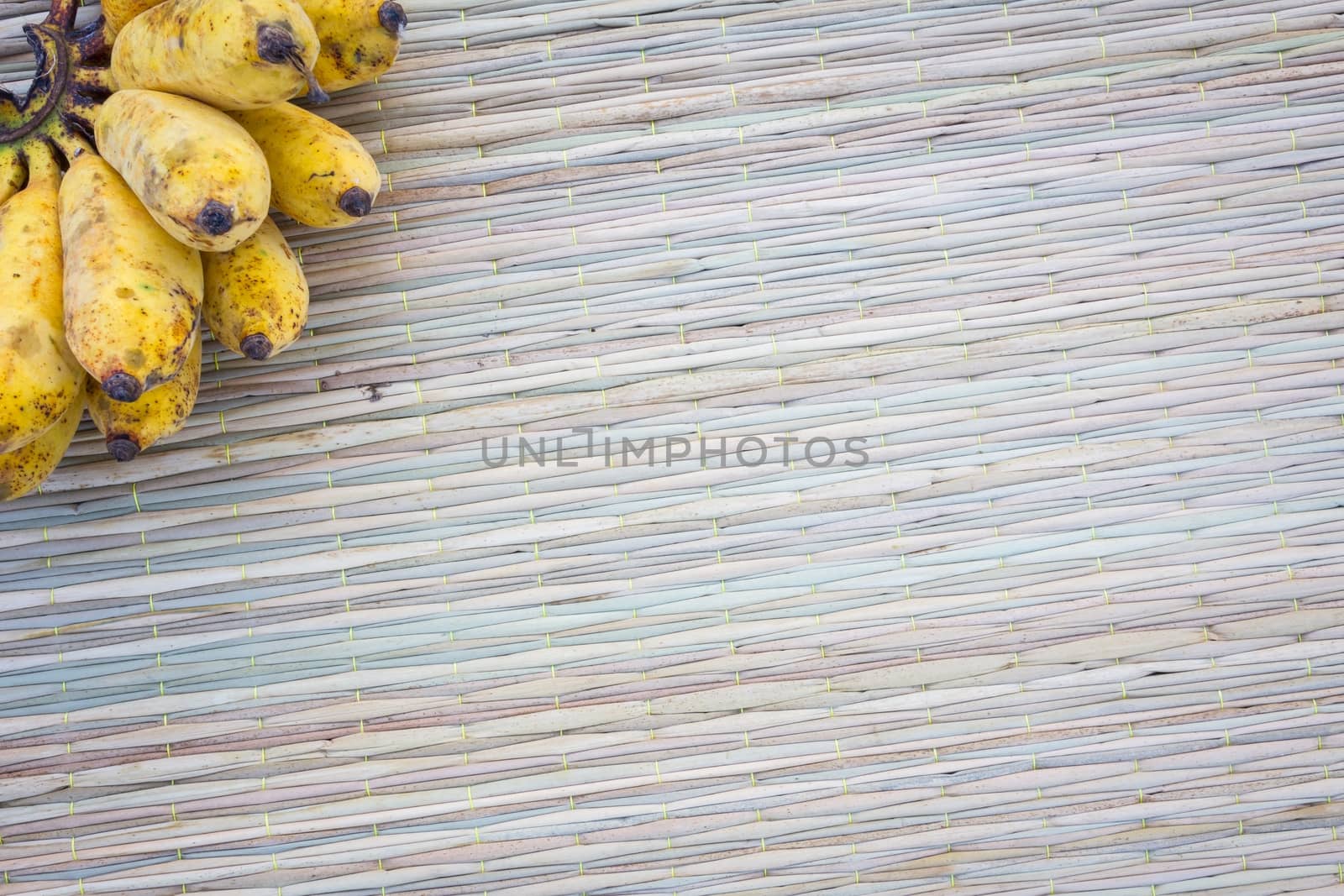 Close up bananas on thai traditional mat, with copyspace