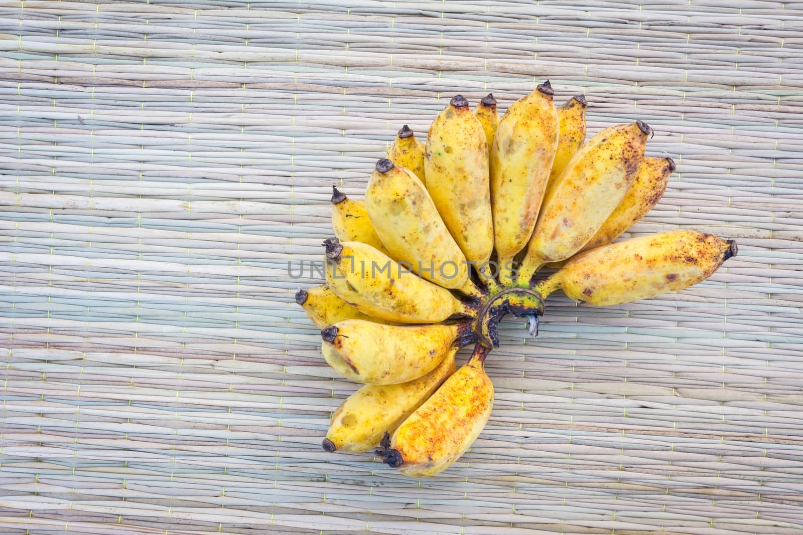 Close up bananas on thai traditional mat, with copyspace