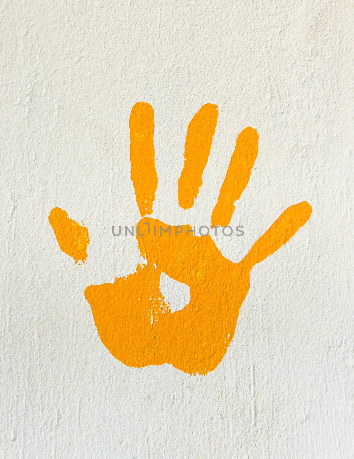 Orange handprint painted on a wall