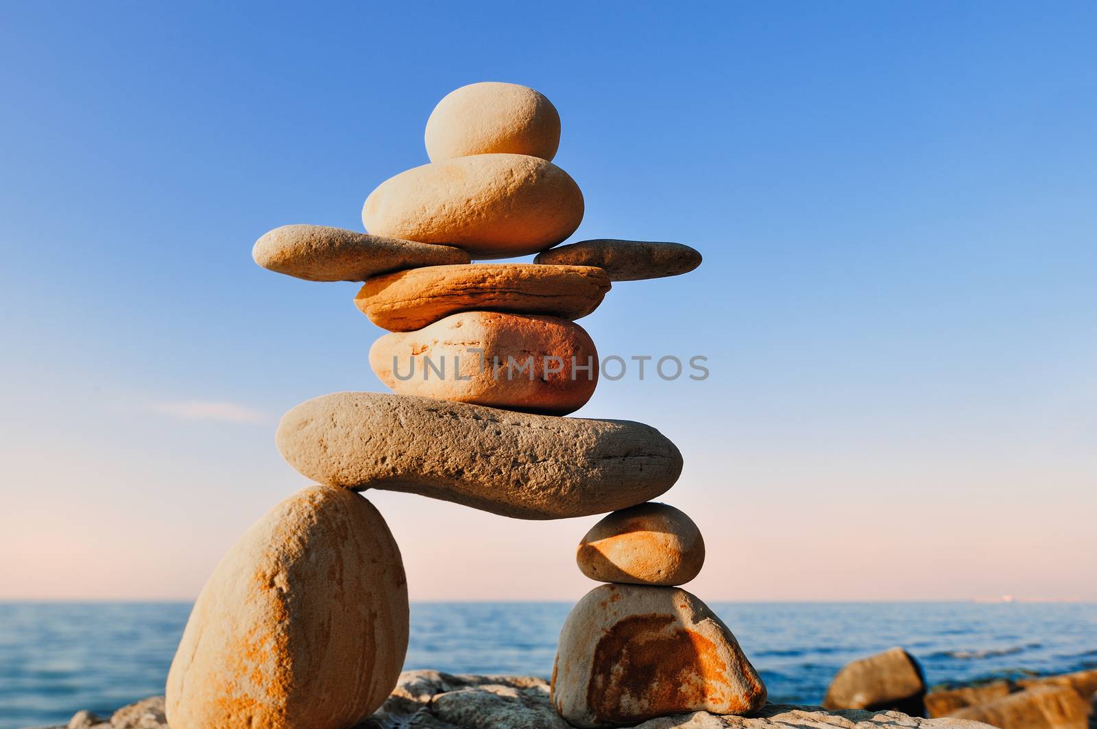Symbolic figurine of inukshuk of the pebbles on the coast