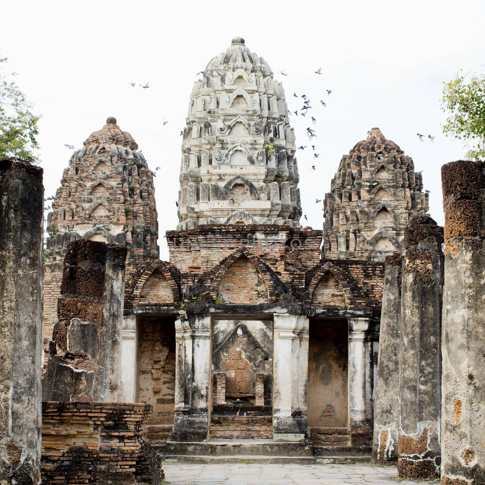 Buddha Statue in Wat Mahathat Temple in Sukhothai Historical park at sunrise, Thailand