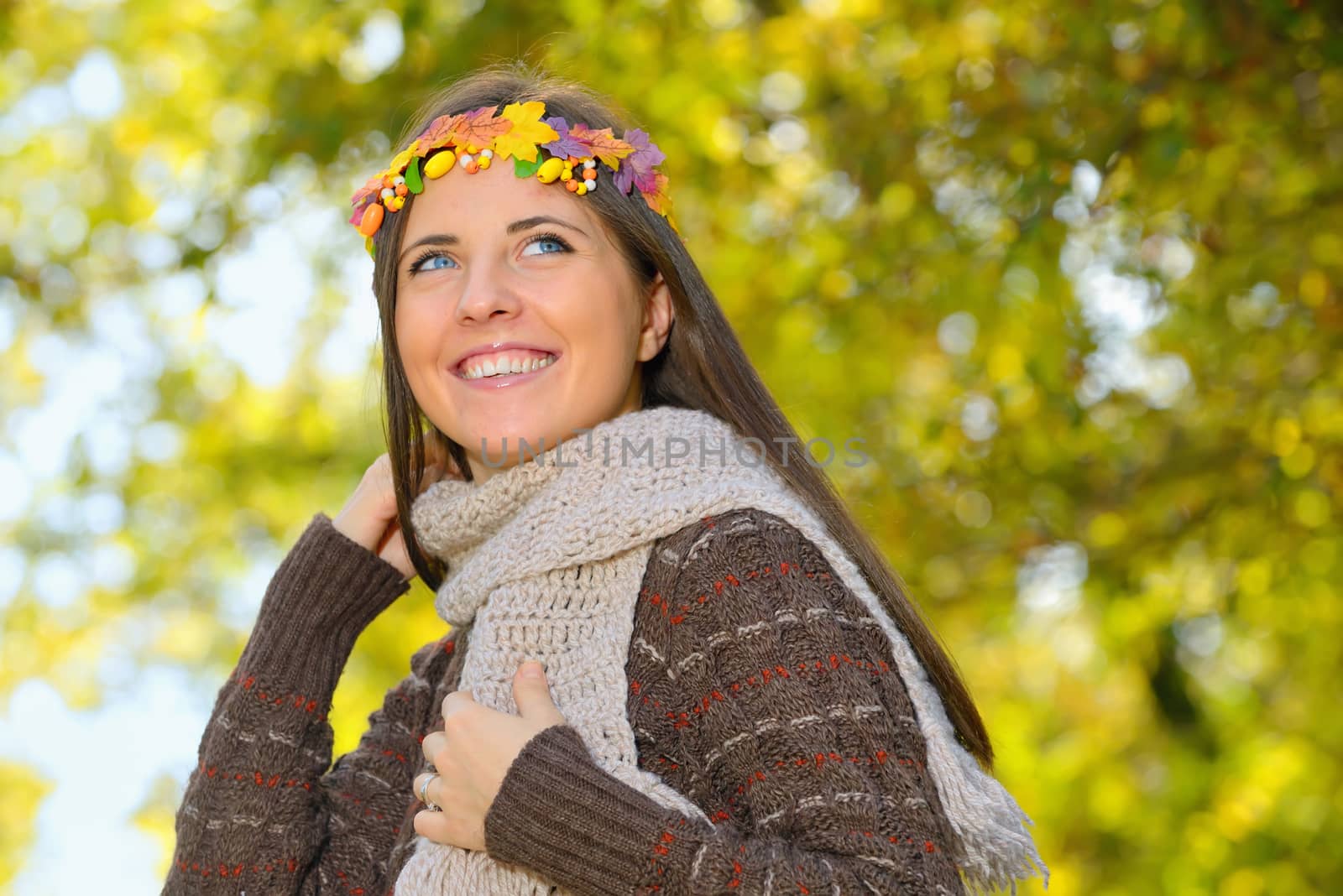 portrait of girl wearing head wreath of autumn leaves