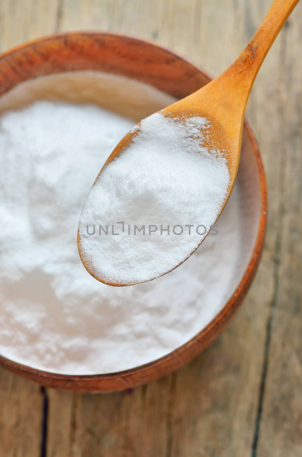 Close-up of Spoon of baking soda over bowl of baking soda