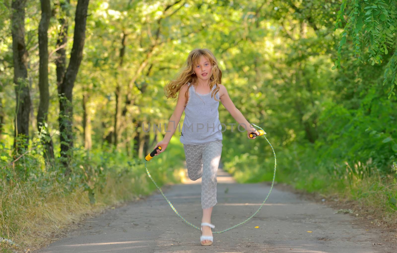 little girl jumps over rope by mady70