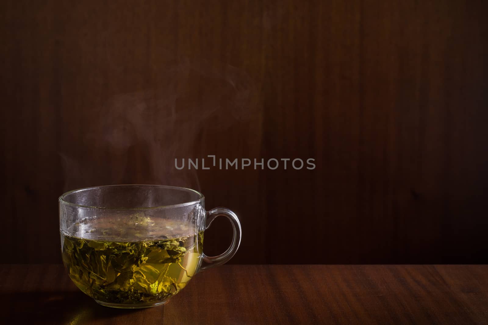 Green tea on wood background.