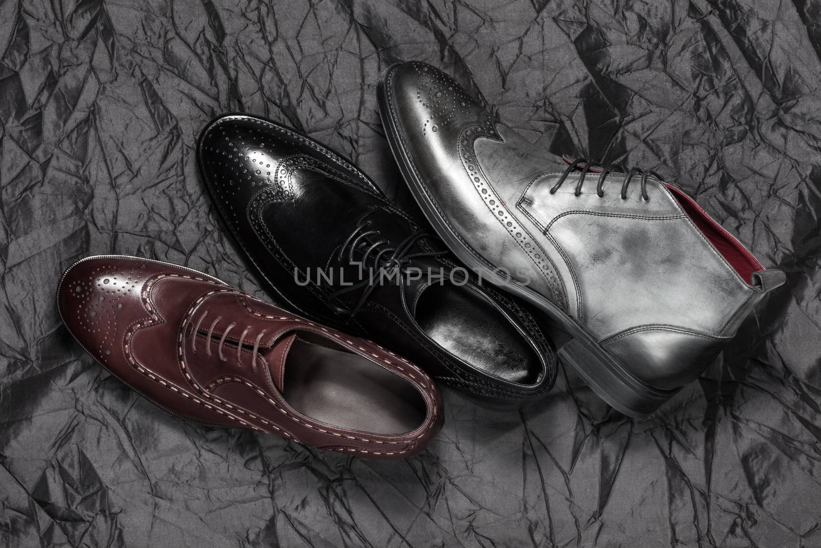 Set of man footwear on a black background by sarymsakov