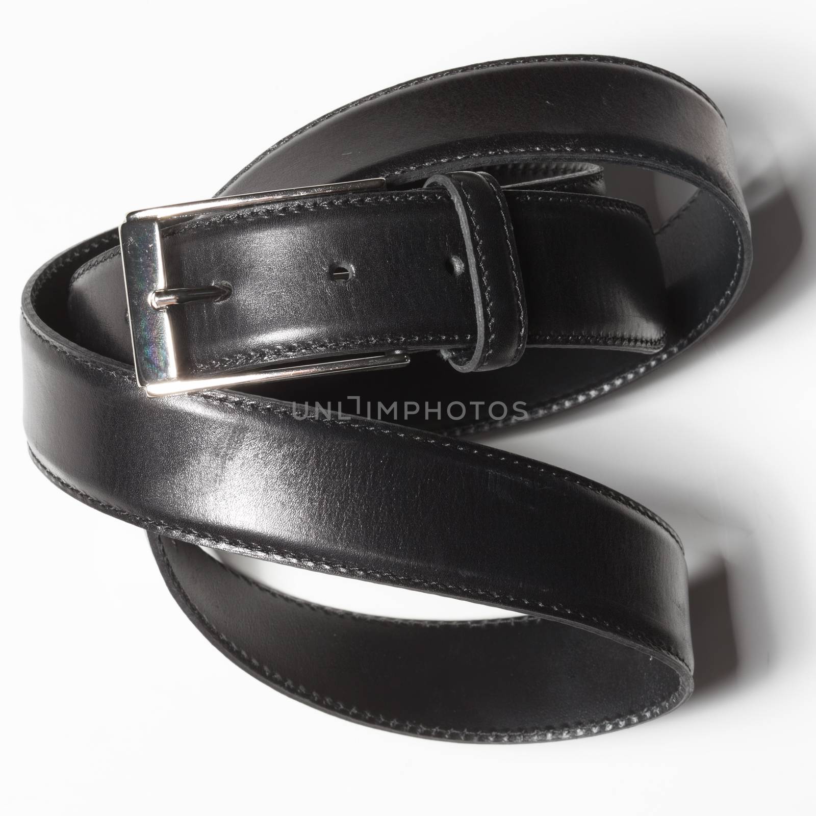 Black belt with a simple buckle on white background by sarymsakov