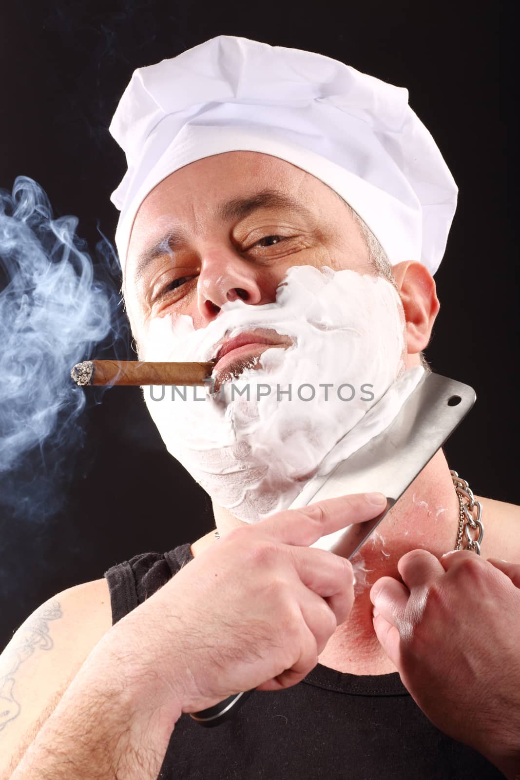 chef shaves with chopper over black