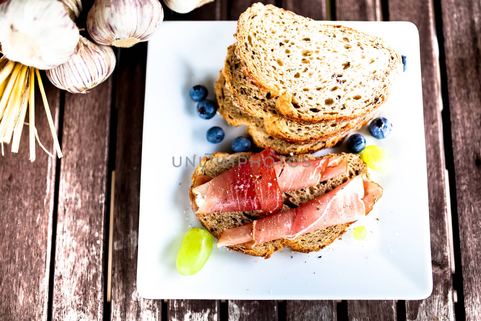 Parma ham on bread on the white plate