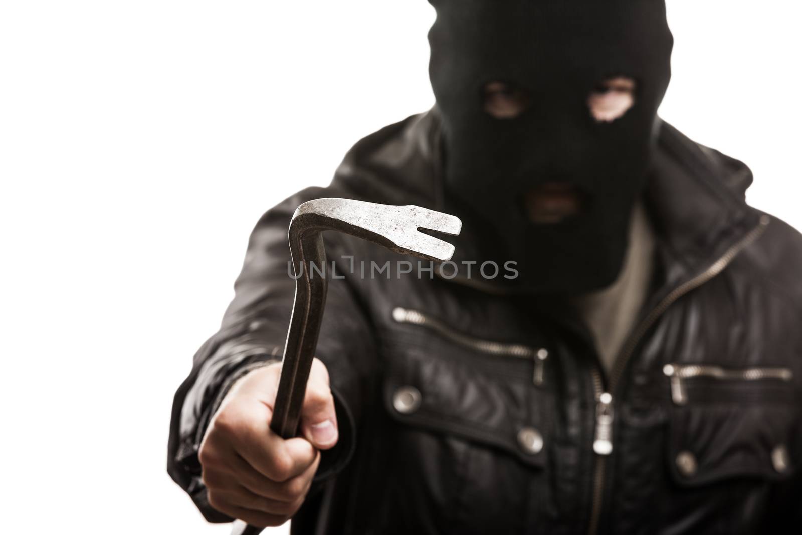 Crime scene - criminal thief or burglar man in balaclava or mask covering face holding crowbar in hand for break opening home door lock