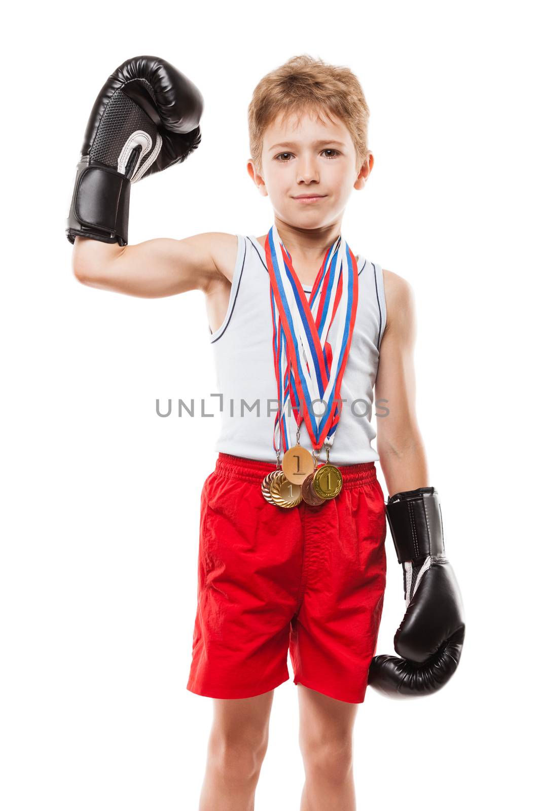 Martial art sport success and win concept - smiling boxing champion child boy holding first place victory gold medal award