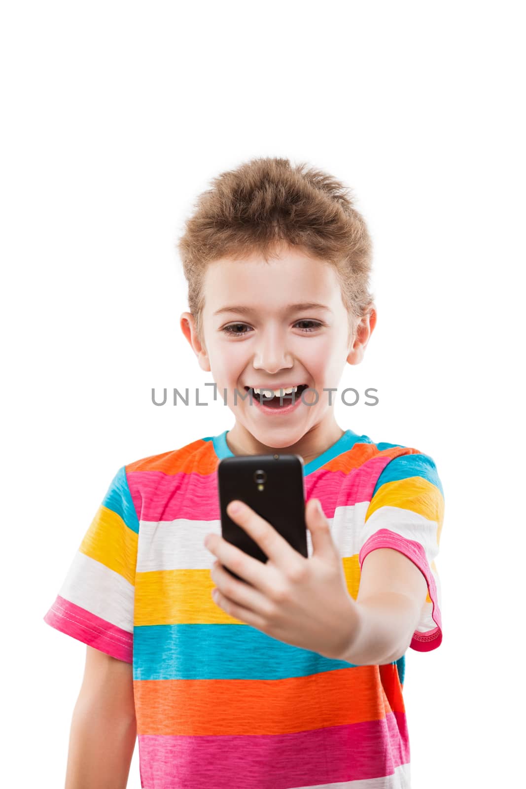 Smiling child boy holding mobile phone or smartphone taking self by ia_64