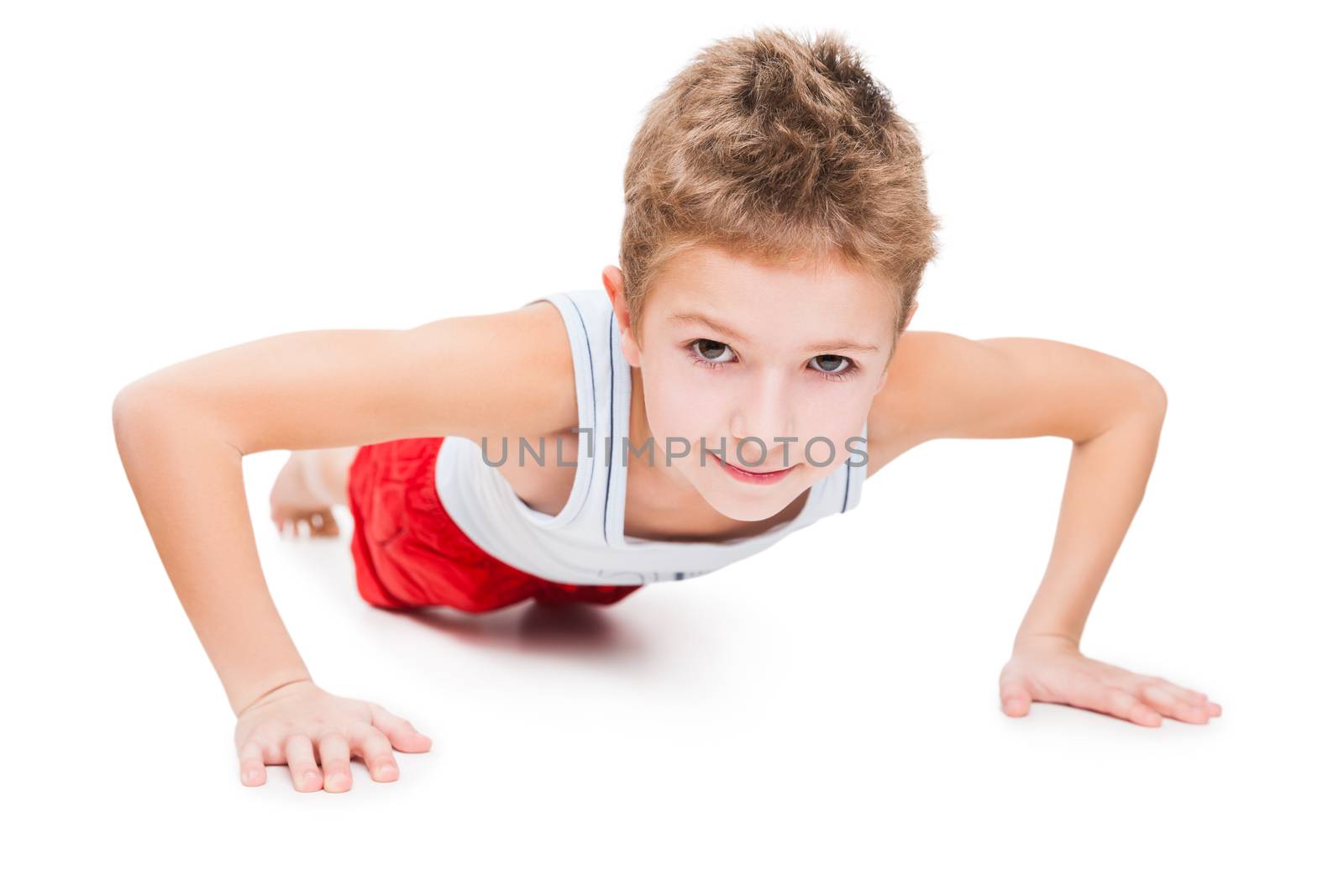 Beauty smiling sport child boy press up exercising white isolated
