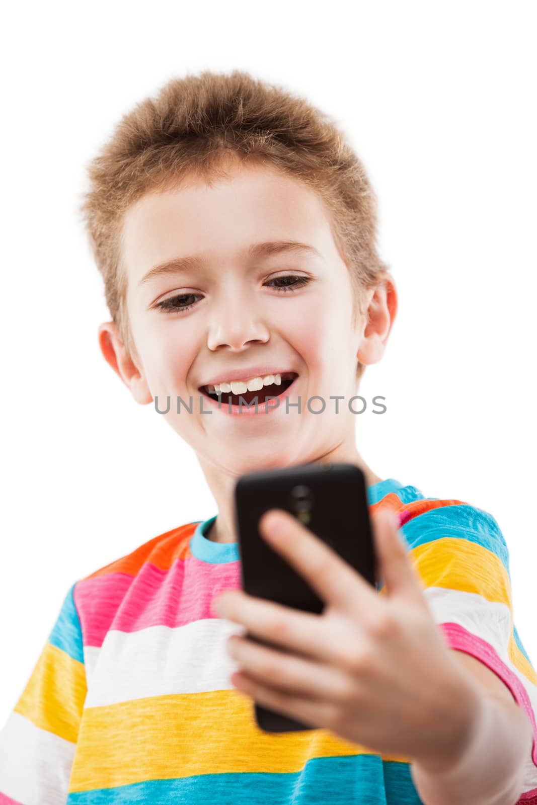 Smiling child boy holding mobile phone or smartphone taking self by ia_64