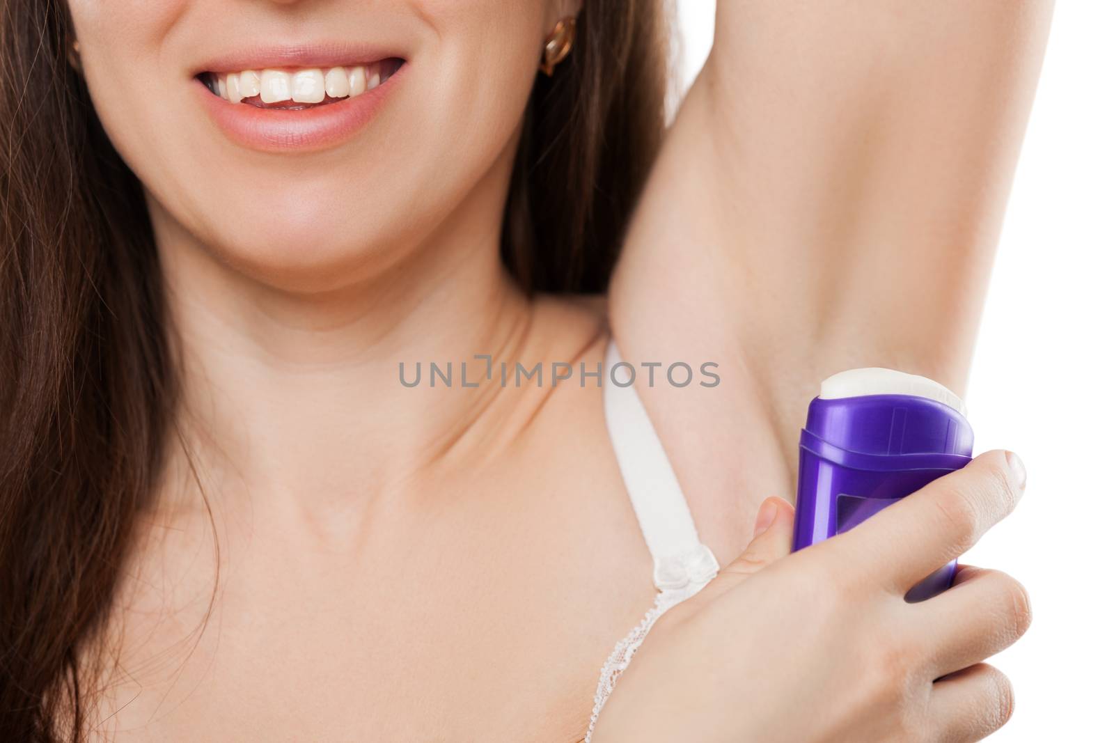 Beauty toothy smiling young woman hand holding stick deodorant applying on armpit skin for sweat or perspiration smell treatment white isolated