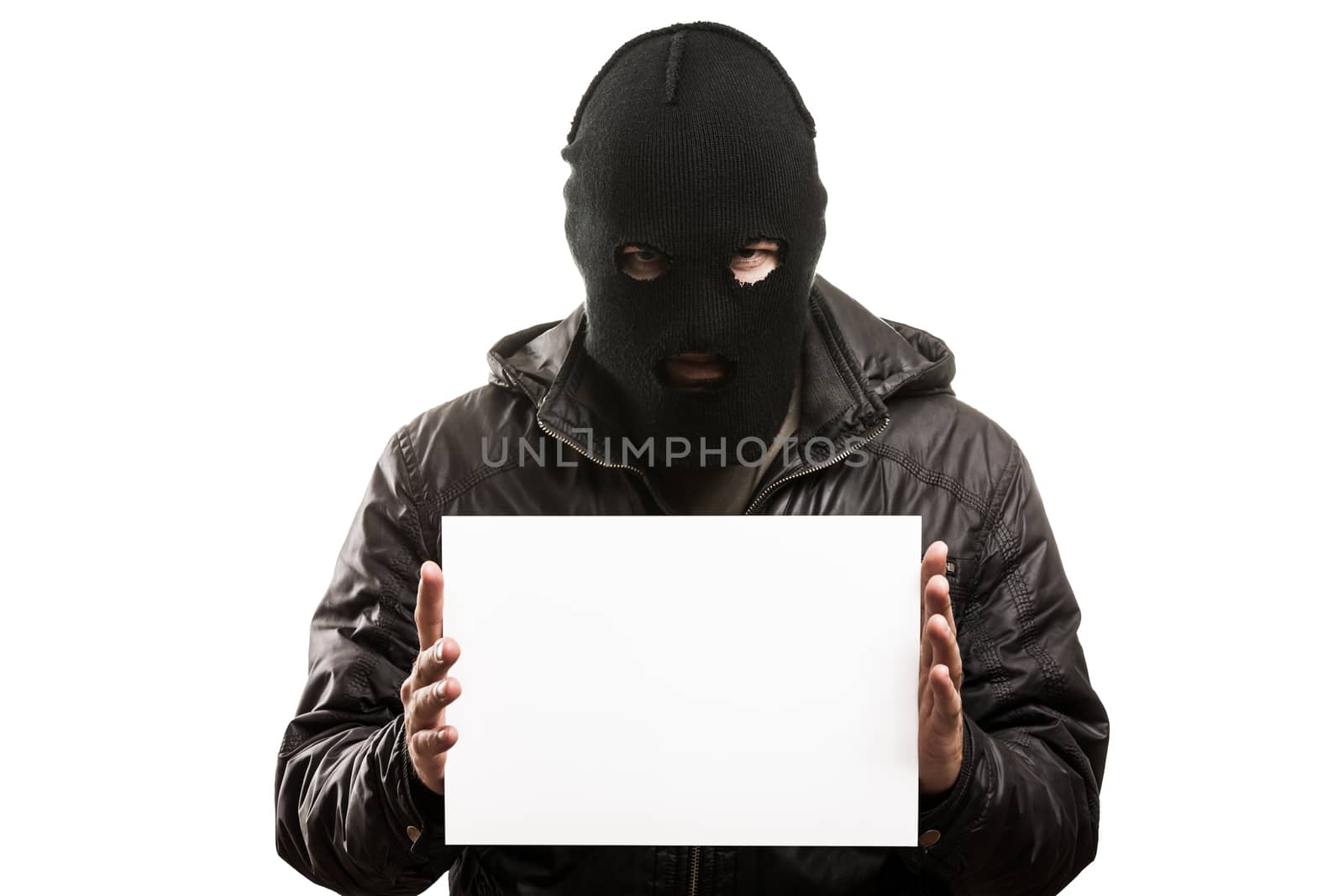 Criminal man in balaclava or mask covering face holding blank wh by ia_64