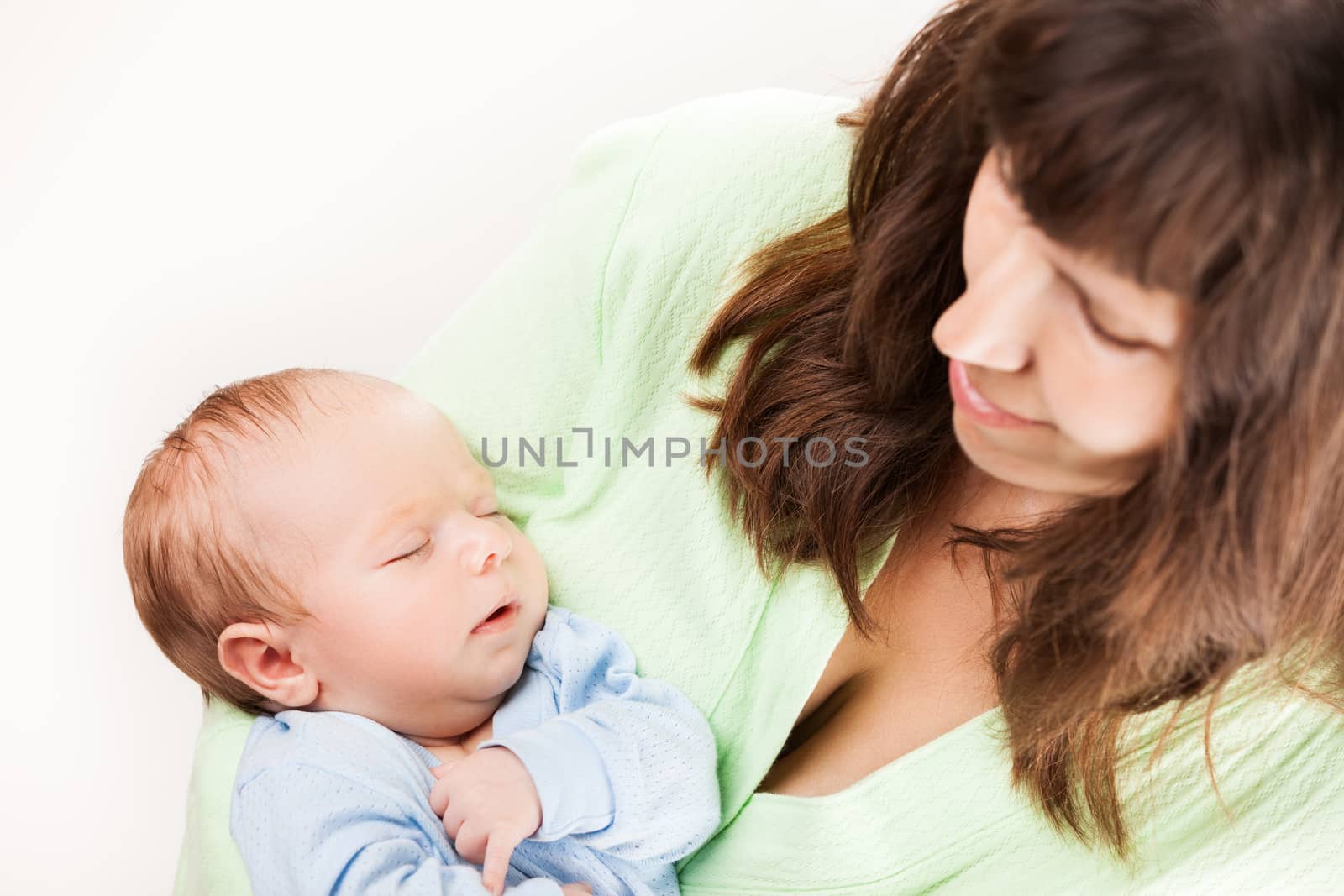 Cute sleeping newborn baby child on mother hands by ia_64