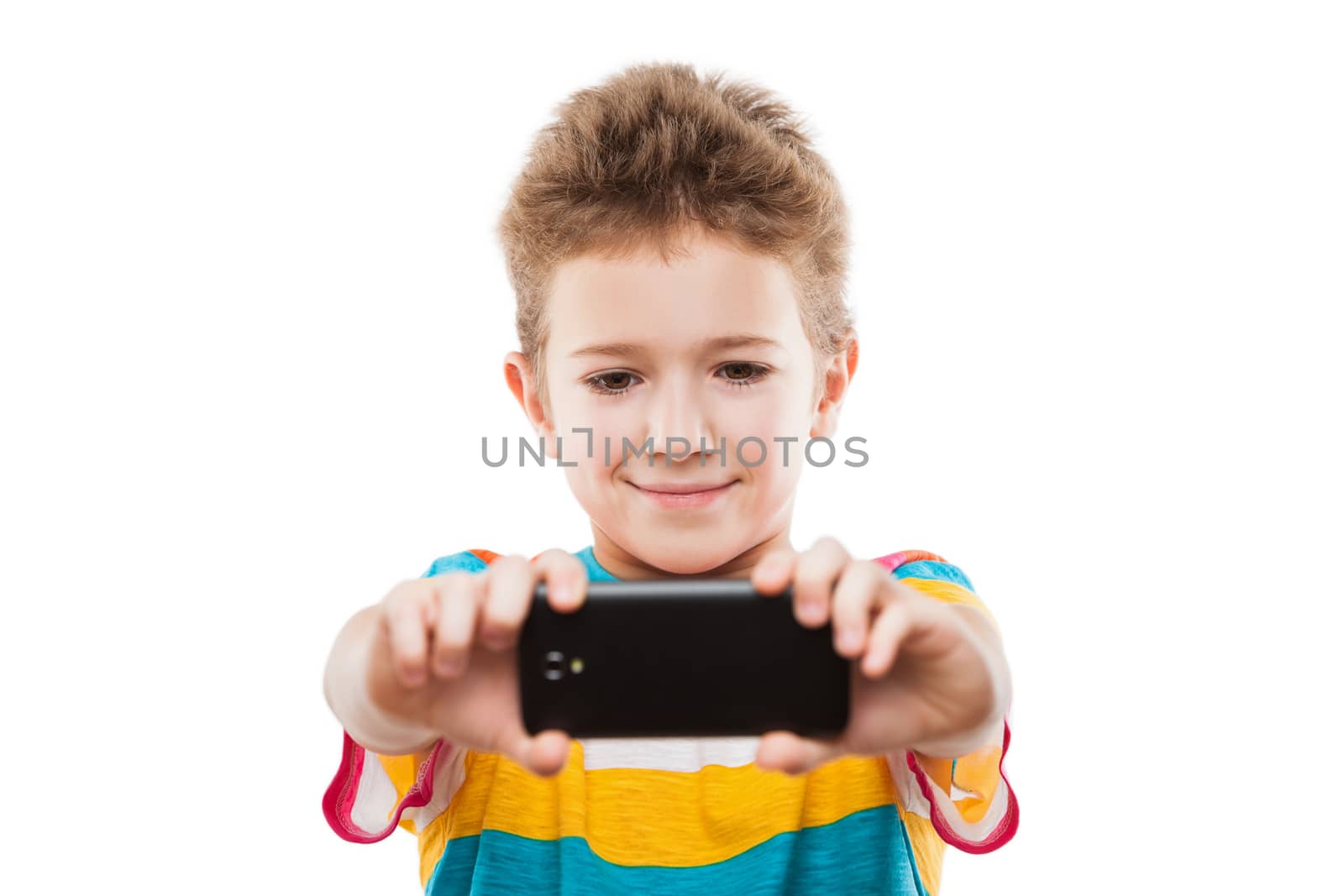 Little smiling child boy hand holding mobile phone or smartphone making selfie portrait photo white isolated