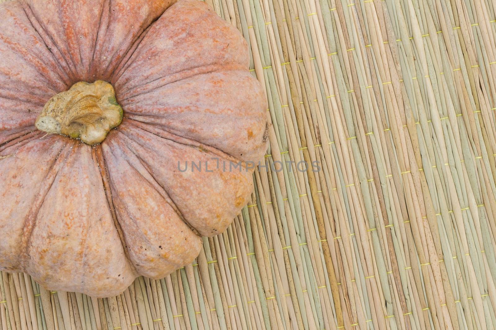 Still Life pumpkin on traditional mat with copyspace on the right, close-up by a3701027