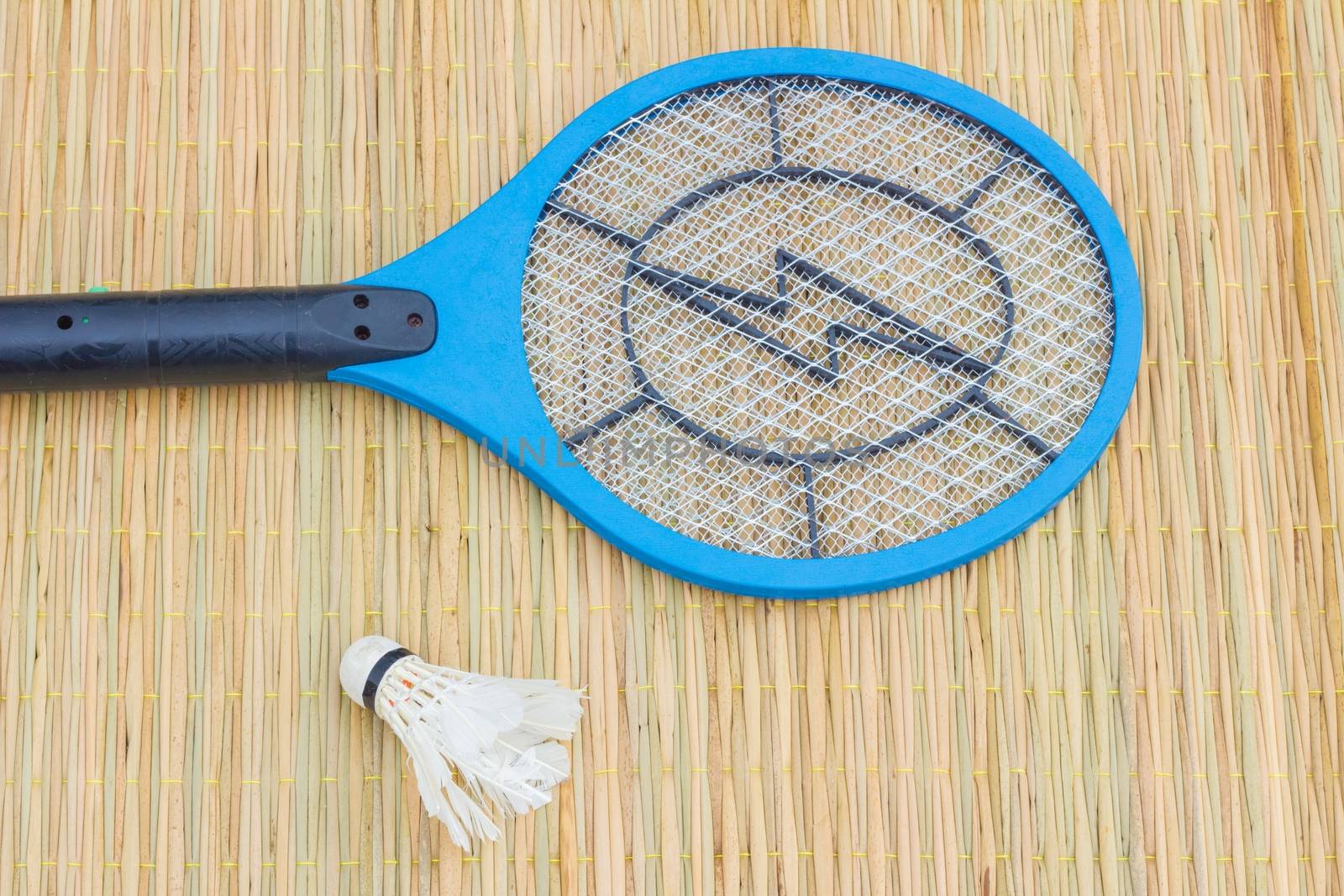 blue electronic mosquito trap and shuttle cock on traditional mat, concept killing is sport