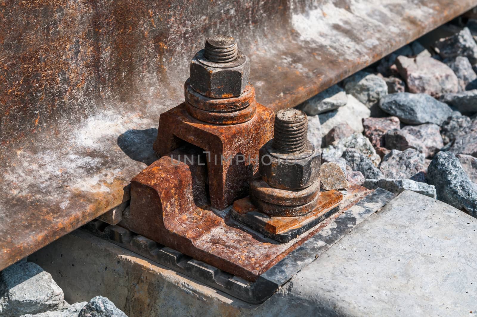 Railroad nut and bolt on background of gravel