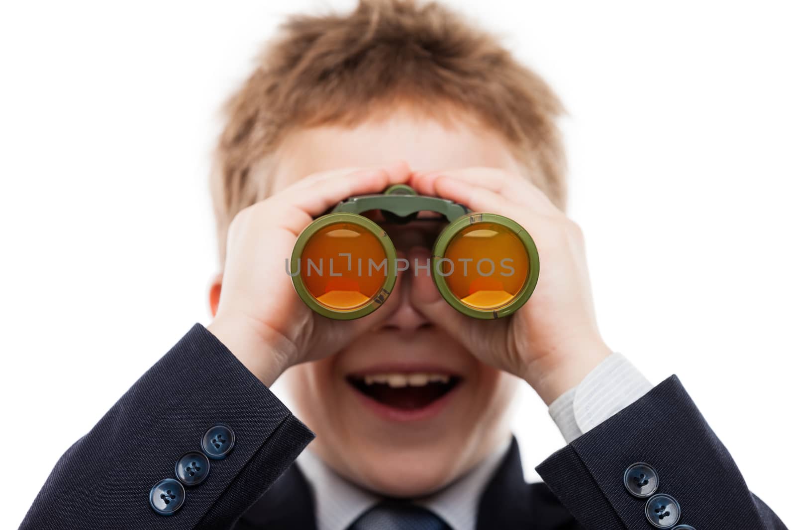 Little smiling child boy in business suit hand holding binoculars lens looking for direction white isolated